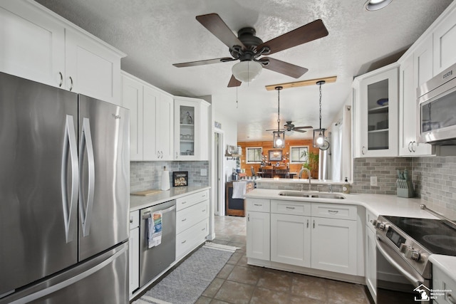 3131 Morin Point St, Erie, MI 48133 - kitchen with stainless steel appliances, a sink, light countertops, a ceiling fan, and decorative backsplash