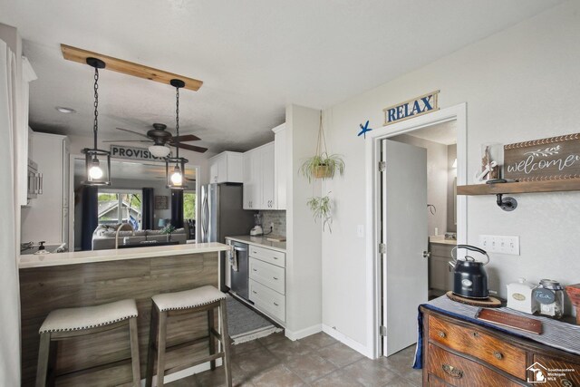 3131 Morin Point St, Erie, MI 48133 - kitchen with dishwasher, white cabinetry, ceiling fan, light countertops, and pendant lighting