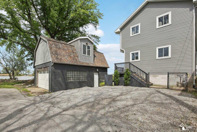 3131 Morin Point St, Erie, MI 48133 - view of side of home with a shingled roof, a garage, an outdoor structure, and a gambrel roof