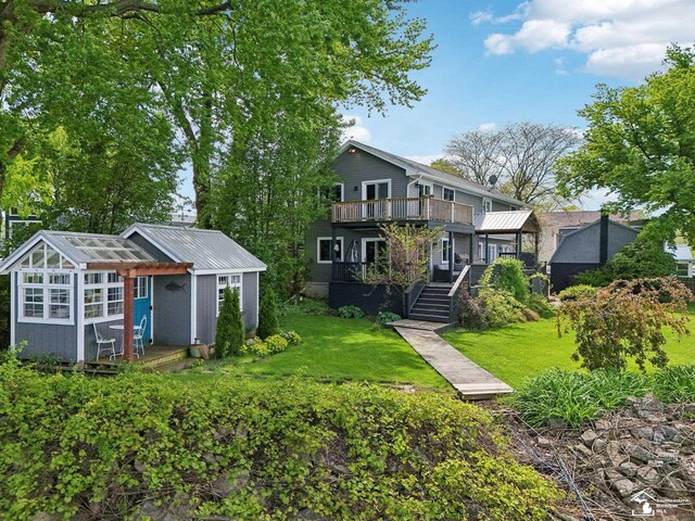 3131 Morin Point St, Erie, MI 48133 - rear view of house with a yard, metal roof, an outbuilding, and a deck