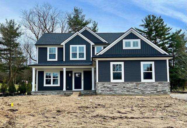 6514 Cambridge Cir, Clarkston, MI 48346 - view of front of house with board and batten siding, a porch, stone siding, and a shingled roof