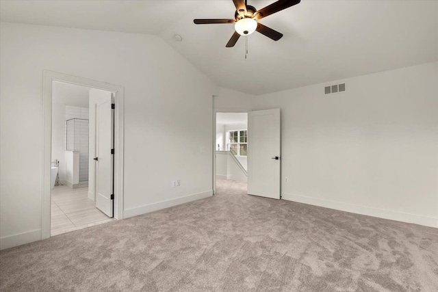 6514 Cambridge Cir, Clarkston, MI 48346 - unfurnished bedroom featuring vaulted ceiling, light colored carpet, baseboards, ensuite bathroom, and ceiling fan