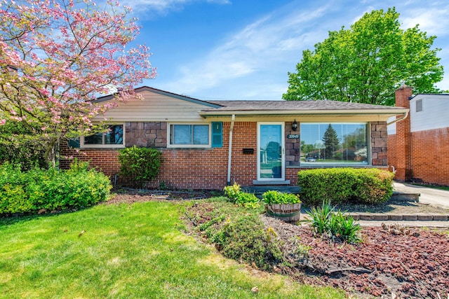 33945 Birchwood St, Westland, MI 48186 - view of front of house with a front yard, stone siding, brick siding, and a chimney