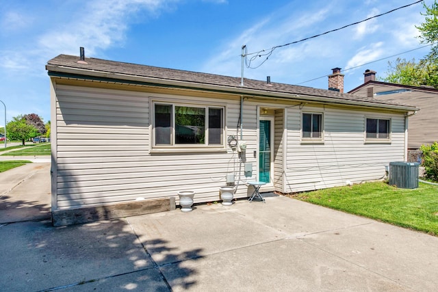 33945 Birchwood St, Westland, MI 48186 - rear view of house featuring central AC, a patio, and a yard