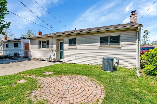 33945 Birchwood St, Westland, MI 48186 - view of front facade featuring a chimney and central AC unit