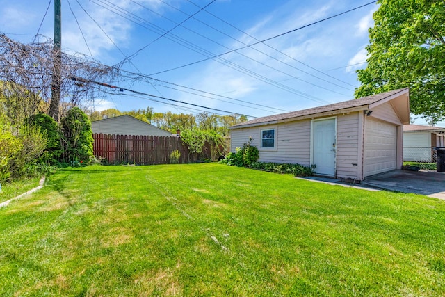 33945 Birchwood St, Westland, MI 48186 - view of yard featuring an outbuilding, driveway, and a detached garage