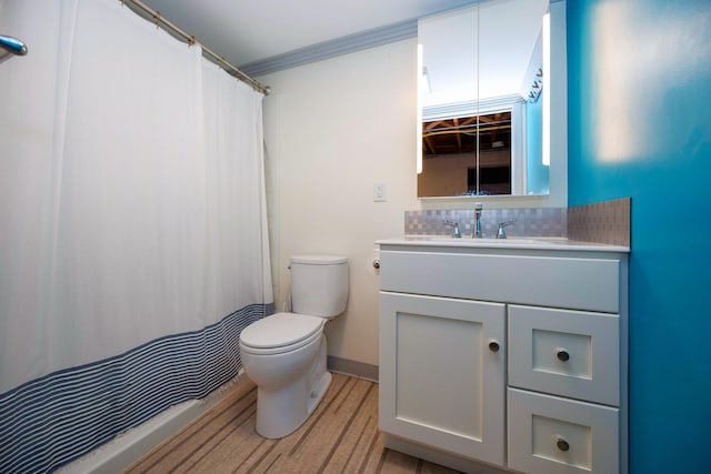1066 Knight Rd, Ann Arbor, MI 48103 - bathroom with toilet, vanity, tasteful backsplash, and ornamental molding