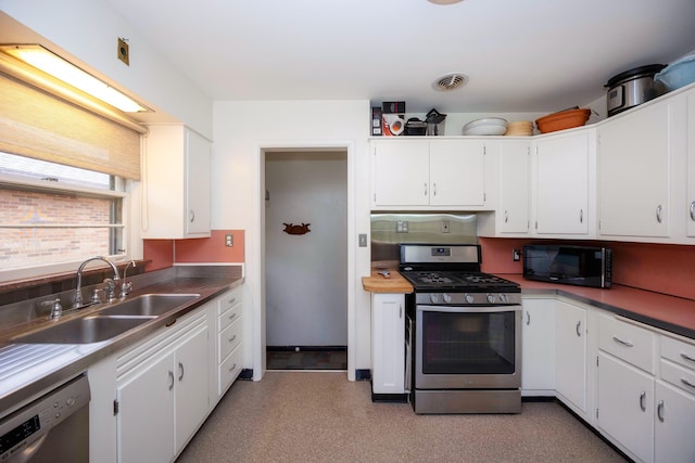 1066 Knight Rd, Ann Arbor, MI 48103 - kitchen featuring appliances with stainless steel finishes, a sink, and white cabinetry