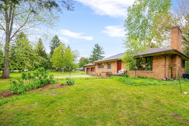 1066 Knight Rd, Ann Arbor, MI 48103 - view of green lawn featuring a garage