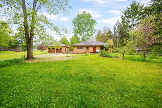 1066 Knight Rd, Ann Arbor, MI 48103 - view of grassy yard featuring an outbuilding and driveway