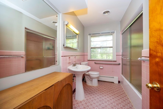 1066 Knight Rd, Ann Arbor, MI 48103 - full bathroom featuring a baseboard radiator, tile walls, tile patterned floors, a wainscoted wall, and toilet