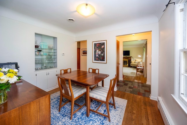 1066 Knight Rd, Ann Arbor, MI 48103 - dining room with baseboard heating, wood finished floors, and baseboards