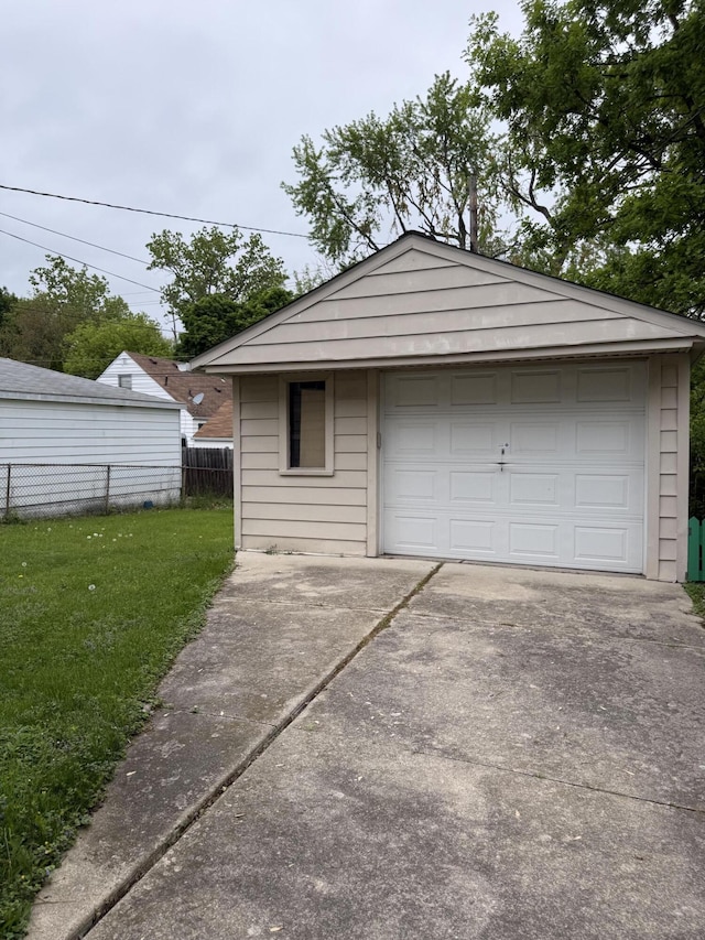 detached garage featuring concrete driveway