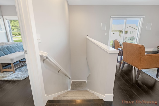 staircase with baseboards and wood finished floors