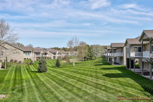 view of home's community featuring a residential view and a yard