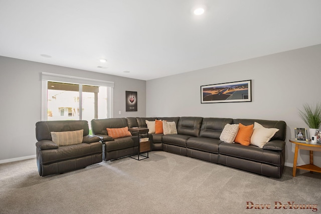 carpeted living area featuring baseboards and recessed lighting
