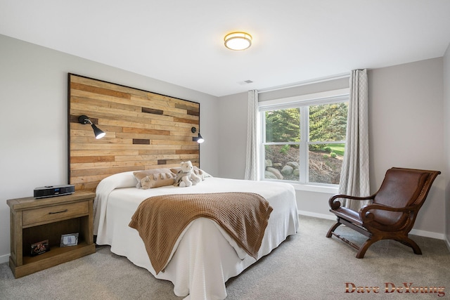 bedroom with light carpet and baseboards