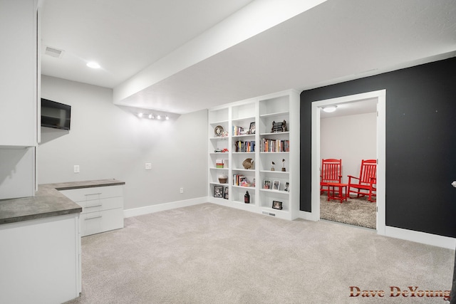 office area featuring light colored carpet and baseboards