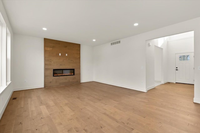 6515 Cambridge Cir, Clarkston, MI 48346 - unfurnished living room with light wood-style floors, a fireplace, baseboards, and recessed lighting