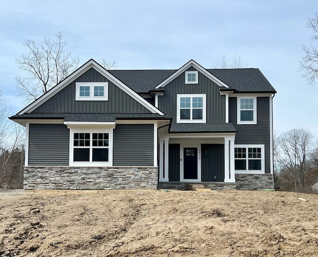 6515 Cambridge Cir, Clarkston, MI 48346 - view of front of home featuring stone siding, board and batten siding, and a shingled roof