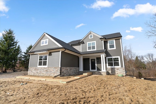 6515 Cambridge Cir, Clarkston, MI 48346 - craftsman inspired home with stone siding, board and batten siding, and roof with shingles