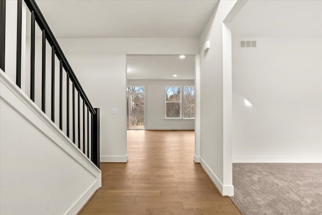 6515 Cambridge Cir, Clarkston, MI 48346 - corridor with baseboards, wood finished floors, stairs, and recessed lighting