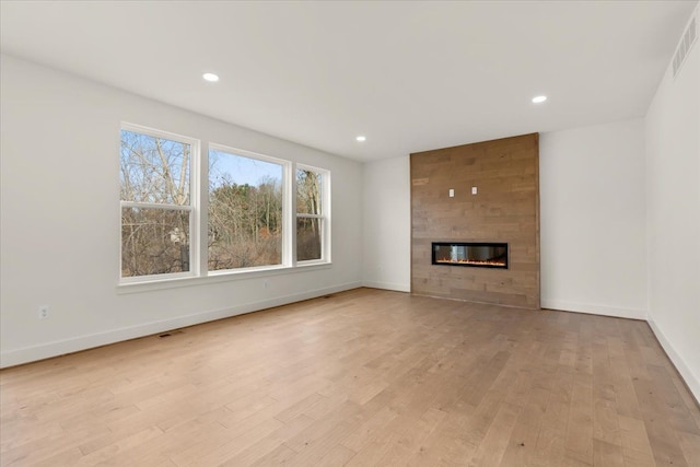 6515 Cambridge Cir, Clarkston, MI 48346 - unfurnished living room with light wood-style flooring, baseboards, a fireplace, and recessed lighting