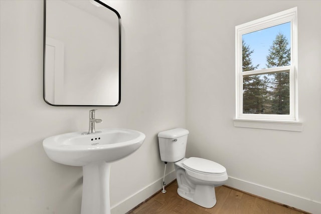 6515 Cambridge Cir, Clarkston, MI 48346 - bathroom featuring baseboards, wood finished floors, and toilet