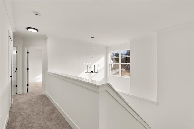 6515 Cambridge Cir, Clarkston, MI 48346 - hallway featuring light colored carpet, an upstairs landing, a chandelier, ornamental molding, and baseboards