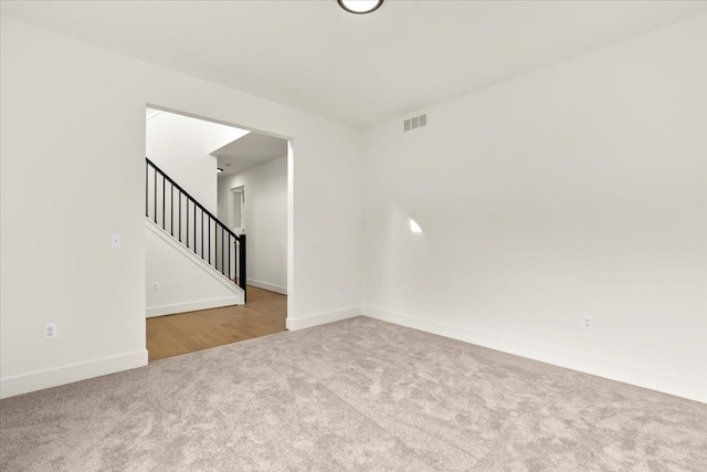 6515 Cambridge Cir, Clarkston, MI 48346 - carpeted spare room featuring baseboards and stairway