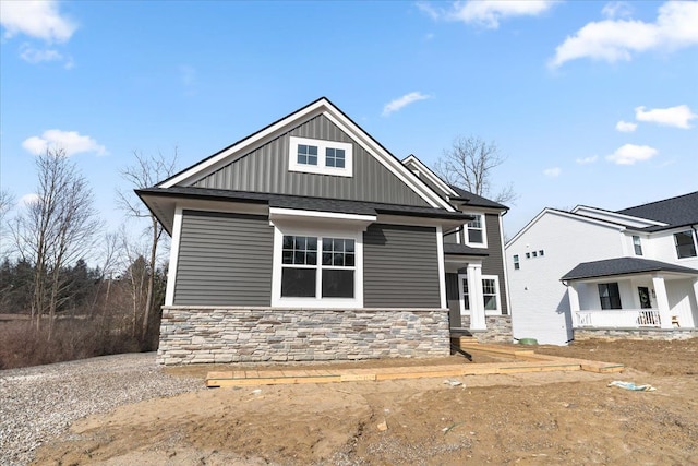 6515 Cambridge Cir, Clarkston, MI 48346 - view of front facade featuring stone siding and board and batten siding