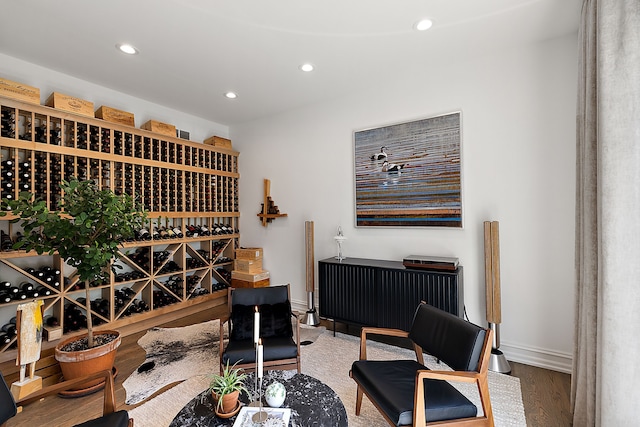 wine room with recessed lighting, wood finished floors, and baseboards