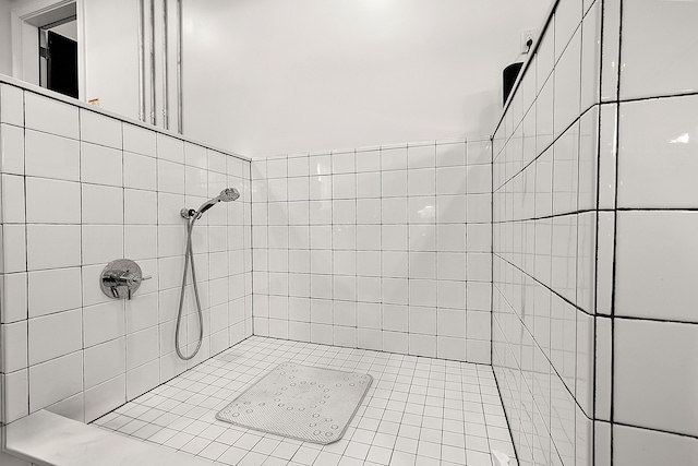 full bath with a tile shower