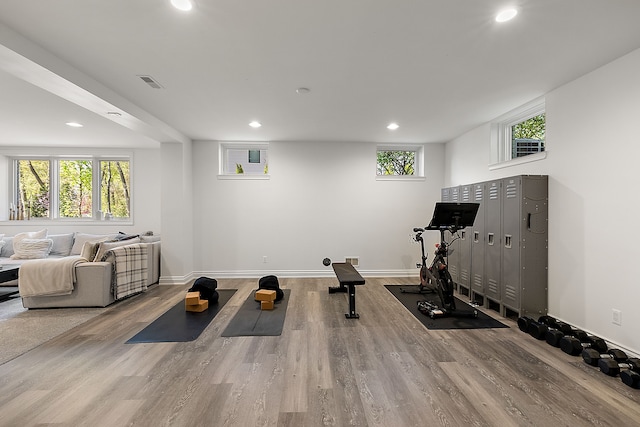workout area featuring wood finished floors, baseboards, and recessed lighting
