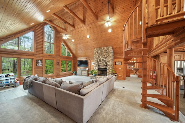 3380 Norvell Rd, Grass Lake, MI 49240 - living room featuring high vaulted ceiling, a ceiling fan, stairs, a stone fireplace, and wooden ceiling