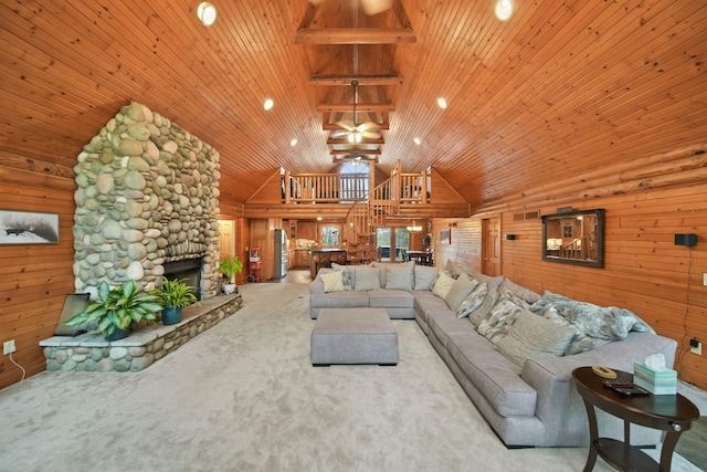 3380 Norvell Rd, Grass Lake, MI 49240 - living area with high vaulted ceiling, carpet, wood ceiling, wood walls, and a stone fireplace