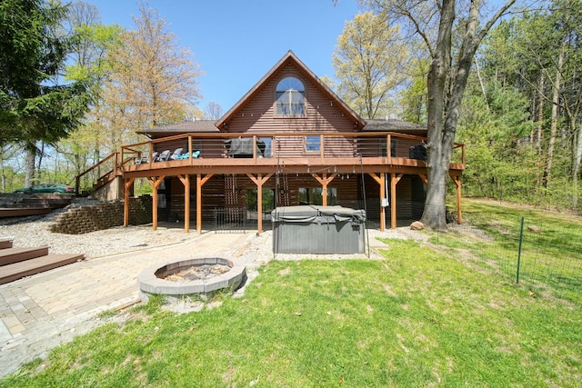 3380 Norvell Rd, Grass Lake, MI 49240 - rear view of house featuring a hot tub, a fire pit, a deck, a yard, and a patio