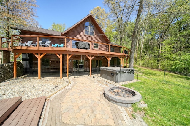 3380 Norvell Rd, Grass Lake, MI 49240 - rear view of house featuring a hot tub, a wooden deck, a lawn, and a patio area