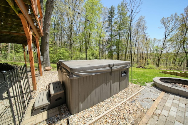 3380 Norvell Rd, Grass Lake, MI 49240 - view of patio / terrace featuring a hot tub, a fire pit, and fence