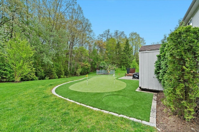 2694 Driftwood Dr, Waterford, MI 48329 - view of grassy yard with an area to practice putting, a shed, and an outdoor structure