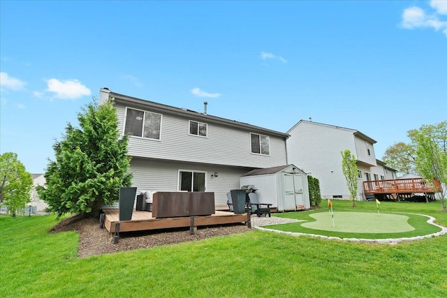 2694 Driftwood Dr, Waterford, MI 48329 - rear view of property featuring a wooden deck, a storage shed, an area to practice putting, an outdoor structure, and a lawn