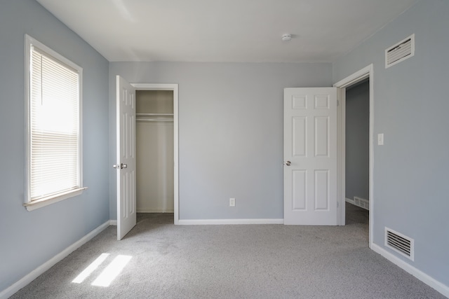 4226 Cadillac Ave, Wayne, MI 48184 - unfurnished bedroom featuring carpet floors, multiple windows, baseboards, and a closet