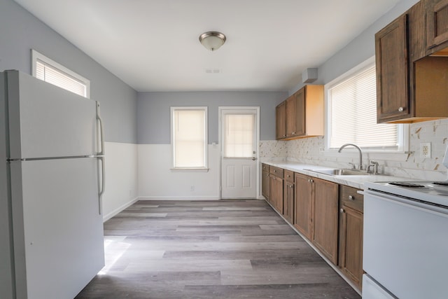 4226 Cadillac Ave, Wayne, MI 48184 - kitchen featuring white appliances, a sink, light countertops, and backsplash