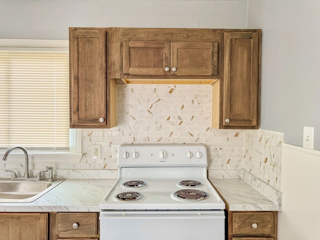 4226 Cadillac Ave, Wayne, MI 48184 - kitchen featuring electric range, a sink, and brown cabinetry