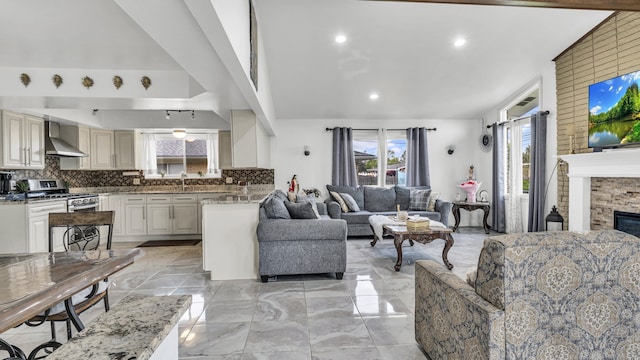 living room featuring light marble finish floors, recessed lighting, and a fireplace