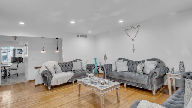 living area featuring light wood finished floors and recessed lighting