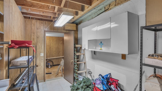misc room with wood walls and light flooring