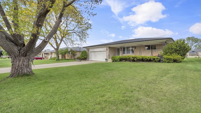 ranch-style house featuring a front yard, an attached garage, concrete driveway, and covered porch