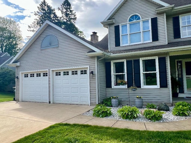 9220 Cotters Ridge Rd, Richland, MI 49083 - traditional home featuring concrete driveway, an attached garage, a chimney, and roof with shingles
