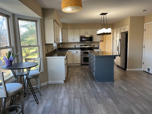 9220 Cotters Ridge Rd, Richland, MI 49083 - kitchen featuring stainless steel appliances, dark countertops, a sink, and white cabinetry